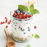 A delicious yogurt parfait with fresh berries and mint leaves, perfect for a healthy breakfast.